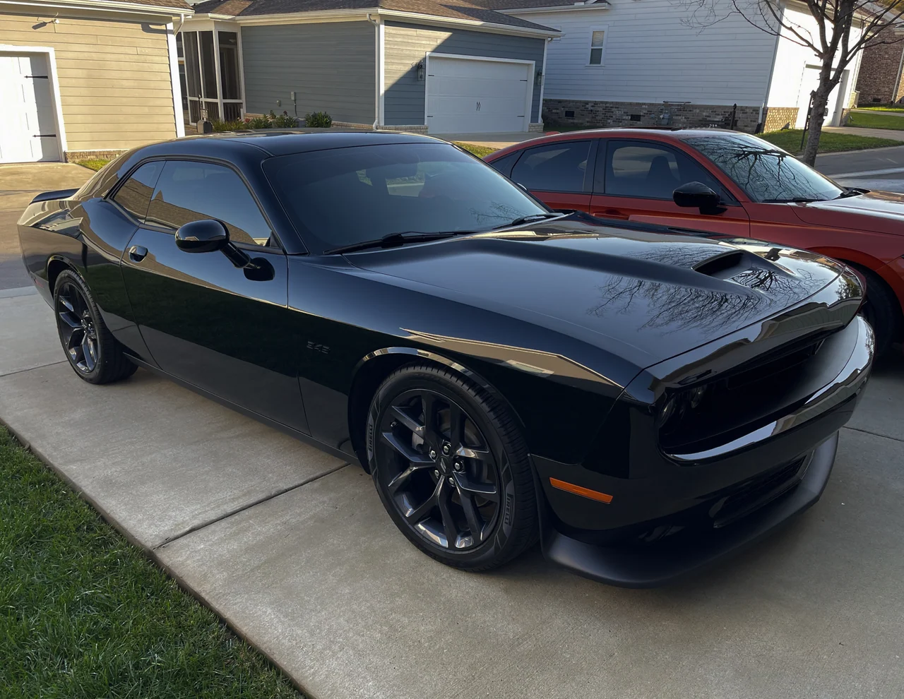 Glossy black Dodge Challenger after professional paint and wheel detailing