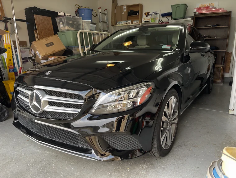 Black Mercedes-Benz sedan detailed inside a residential garage